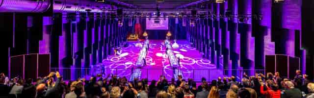 Vibrant foyer in Halle 622, with tiered seating for presentations and fashion shows.