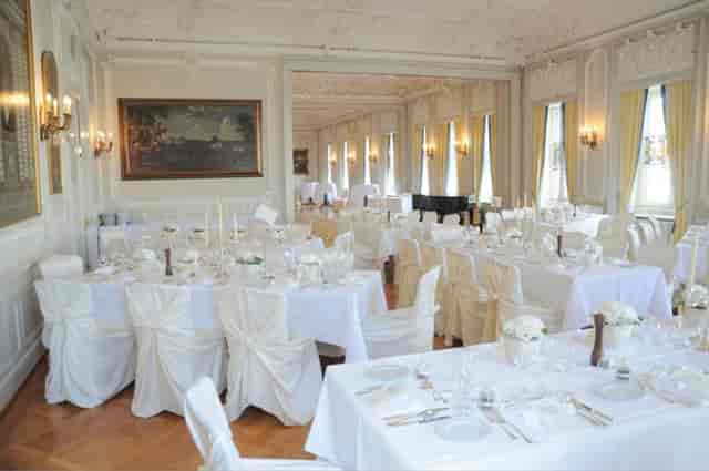 Elegant banquet room with white linens, ideal for upscale weddings and events.