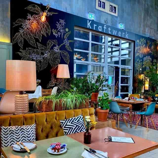 Stylish event space in Kraftwerk with greenery, perfect for creative meetings and receptions.
