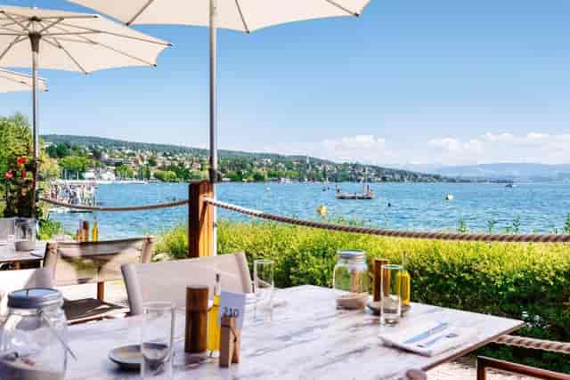 Outdoor dining area at Fuego with waterfront view, ideal for casual meetings or events.