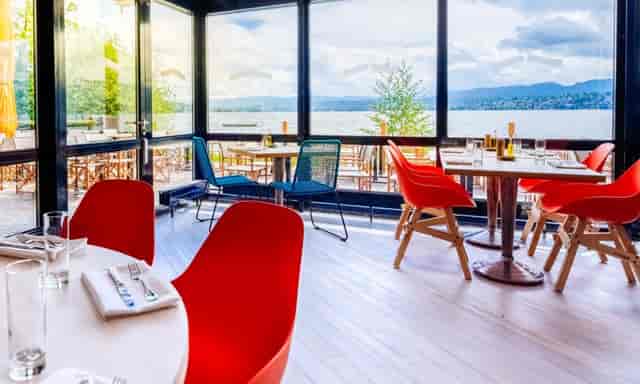 Modern event space in Lake Side with large windows, ideal for meetings and receptions.