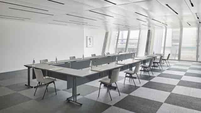 Modern corporate seminar room with natural light, ideal for meetings and presentations.