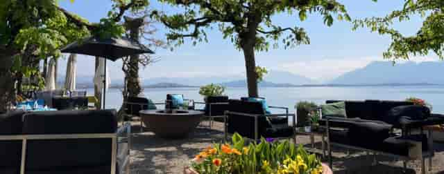 Outdoor meeting space by water with vibrant flowers, perfect for team-building retreats.