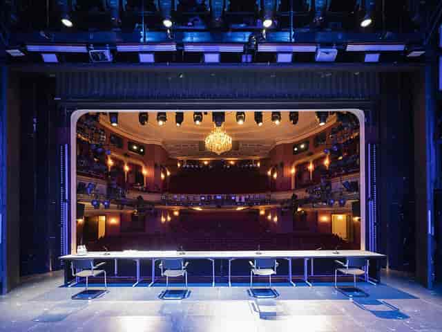 Pfauensaal theater stage with elegant chandelier, ideal for performances and corporate events.