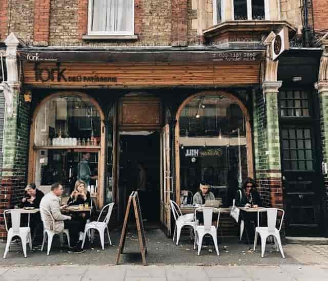 Quaint café with outdoor seating, perfect for networking and casual meetings.