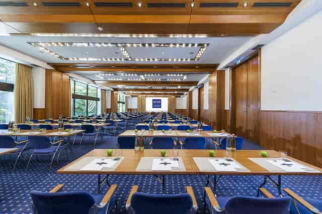 Banquet hall at Dorint Tagungshotels, bright meeting space for conferences and workshops.