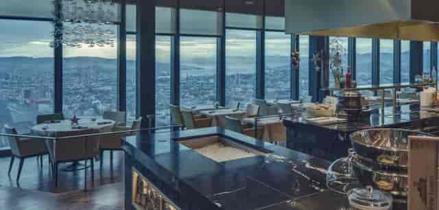 Elegant restaurant dining space with city views, ideal for corporate dinners and upscale events.