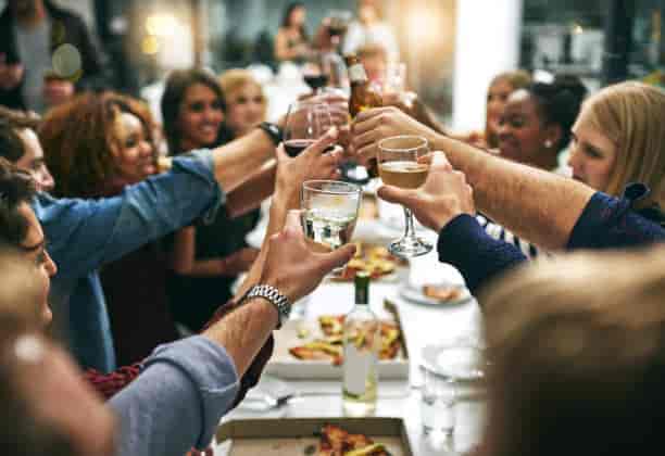 Wine club celebration in AnaMiRa, showcasing a toast at a networking dinner party.