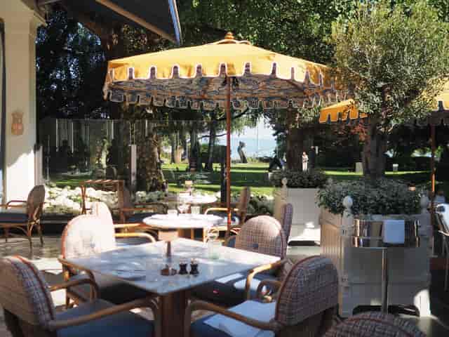 Rooftop dining at Baur au Lac with yellow umbrellas, perfect for events and gatherings.