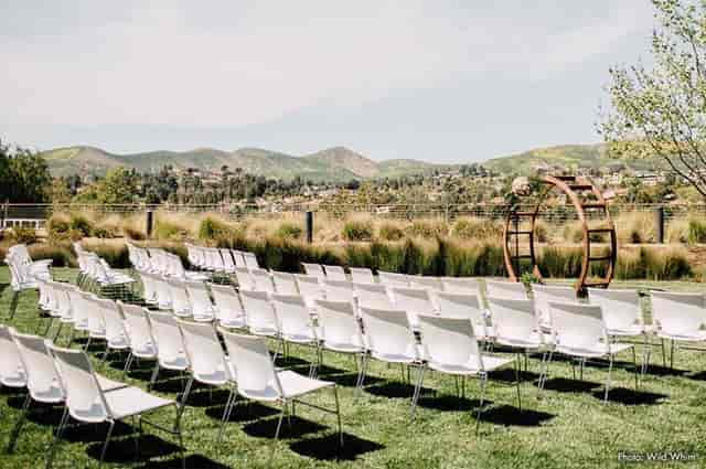Agoura Hills Event Center outdoor wedding setup with white chairs and scenic hills.