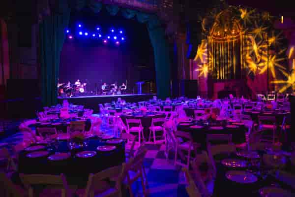 Elegant dinner setup at The Jayne Bar, Fonda Theatre, with vibrant stage lighting.