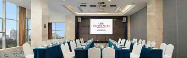 Meeting room at Crowne Plaza Chengdu with teal tables for corporate seminars.