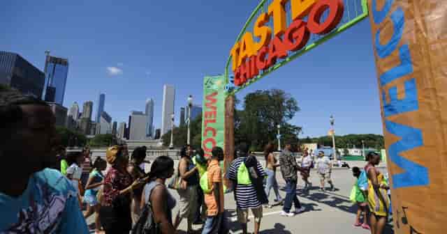 Taste of Chicago festival entrance with vibrant signage and diverse crowd enjoying local cuisine.