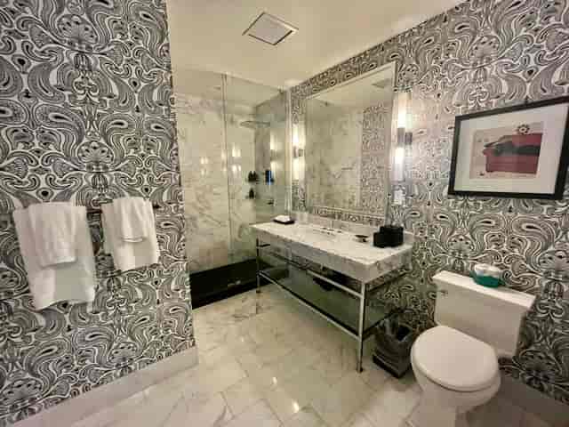 Modern restroom with marble accents and glass shower at Marshall & Fox, perfect for events.