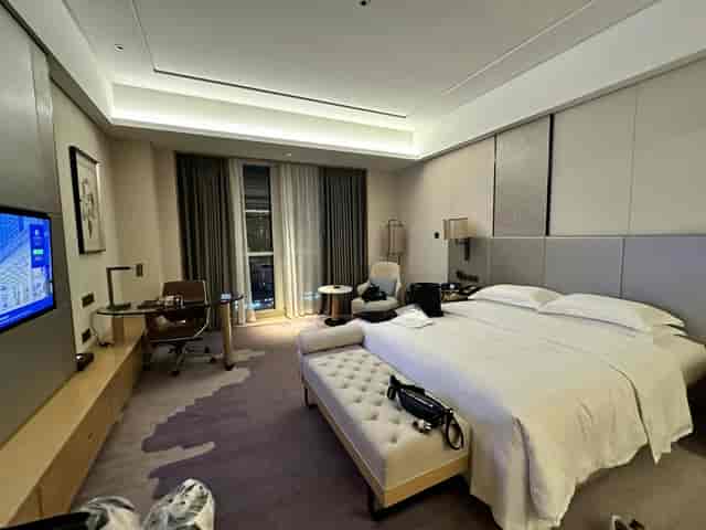 Modern Chengdu hotel room with workspace, ideal for meetings and events.