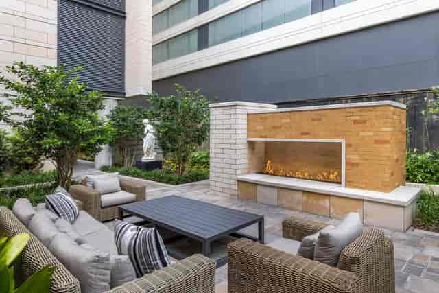 Outdoor event space at La Colombe d'Or with modern fire feature and lush greenery.