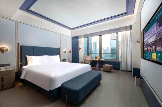Grand Ballroom in Maxx Guangzhou: modern hotel room with king-sized bed, ideal for events.