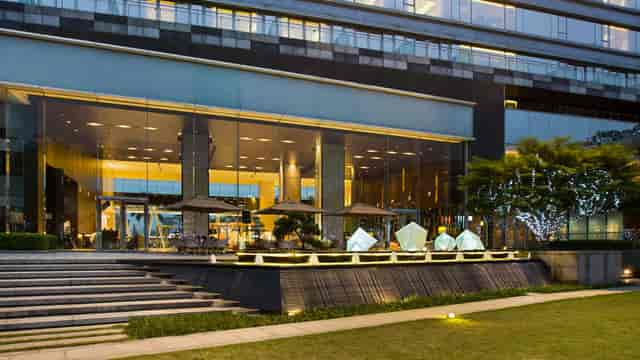 Jade in a modern venue with glass façades, perfect for corporate events and networking.