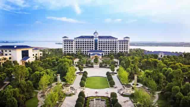Luxurious Evergrande Hotel with lush gardens, perfect for events and retreats.