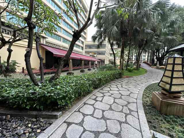Serene Dong Fang Hall outdoor space with lush greenery for networking events.