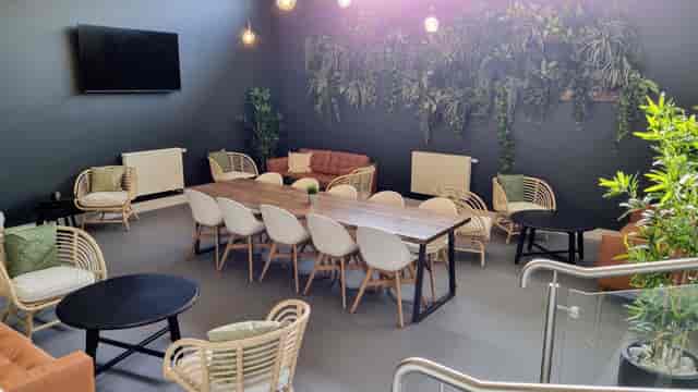 "Modern Riverside Conferencing lounge with large table for networking and brainstorming events."