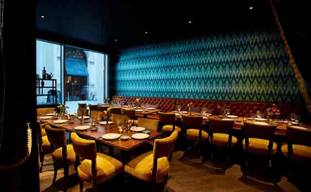 Inti Room in Coya City: modern dining space for corporate meetings, featuring warm decor.