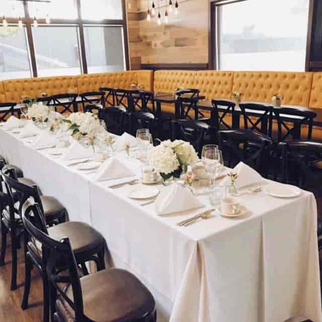 Upscale restaurant patio banquet with yellow banquettes for social or corporate dining events.