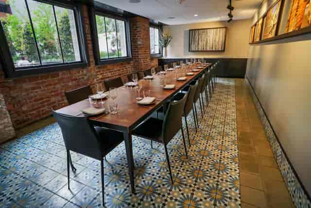 Elegantly set long table in Mourad restaurant for intimate gatherings and events.