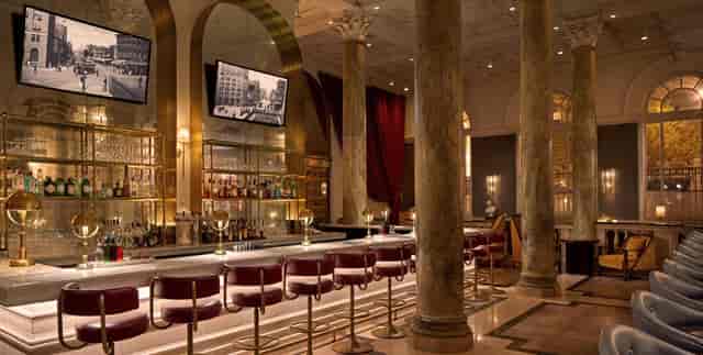 Sophisticated Dishonesty Bar in DC with marble columns, ideal for networking events.