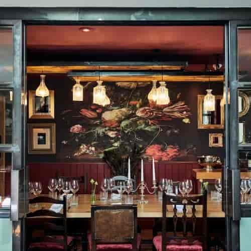 Private dining room at Brooklands Hotel with elegant floral mural, ideal for intimate events.