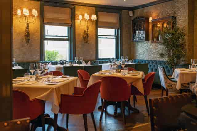 Elegant dining room setting in Judy's, ideal for intimate meetings and small gatherings.
