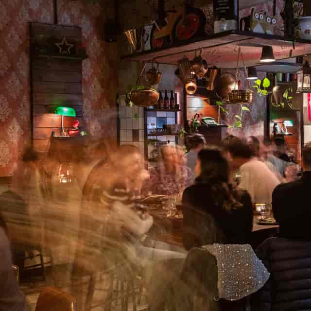 Lively restaurant interior ideal for networking events with warm lighting and vibrant decor.