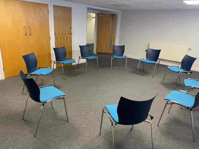Circular chair arrangement in Riverside Conferencing Room for collaborative meetings.