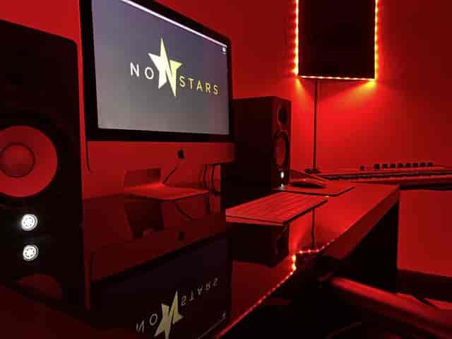 Sleek black workspace with vibrant red lighting for creative meetings and events.