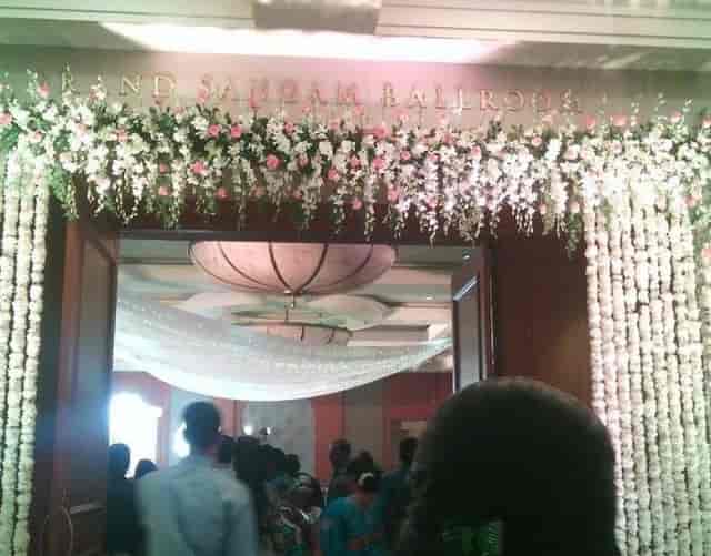 Elegant floral entrance to The Grand Sangam Ballroom, perfect for weddings and events.