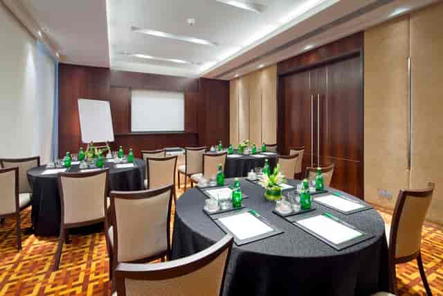 Conference room setup at Courtyard Mumbai with round tables for collaborative workshops.