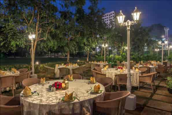 Elegant outdoor dining at a restaurant with soft lantern lighting, perfect for weddings and events.