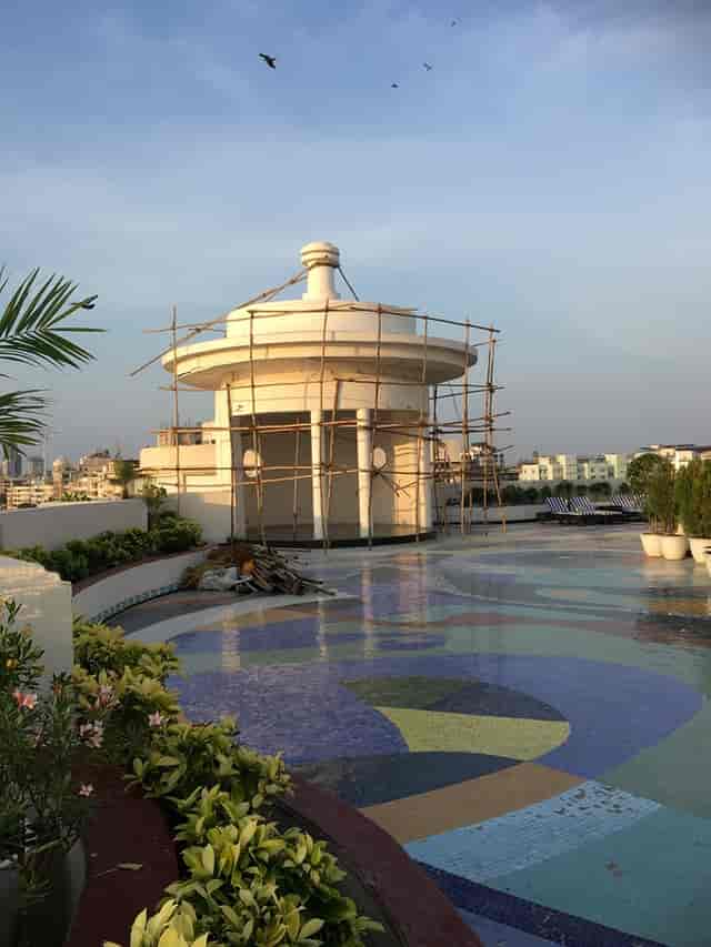 Rooftop pool venue under construction with vibrant tiles and scaffolding for events.
