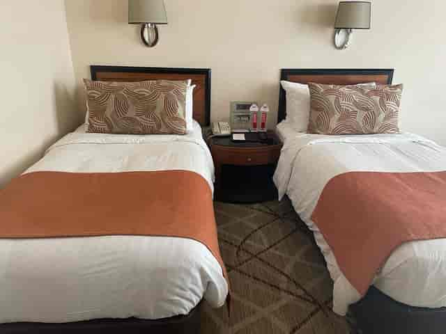 Hotel room with two beds at The Allamanda, perfect for conferences and events.