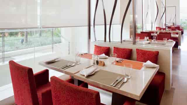 Meeting Room 6 at Holiday Inn Mumbai: elegant dining area with red upholstery for meetings.