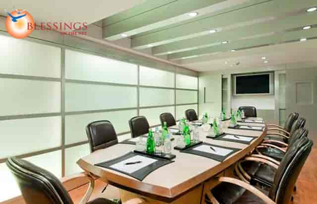 Modern boardroom with oval table in Hilton Mumbai Airport for professional meetings.