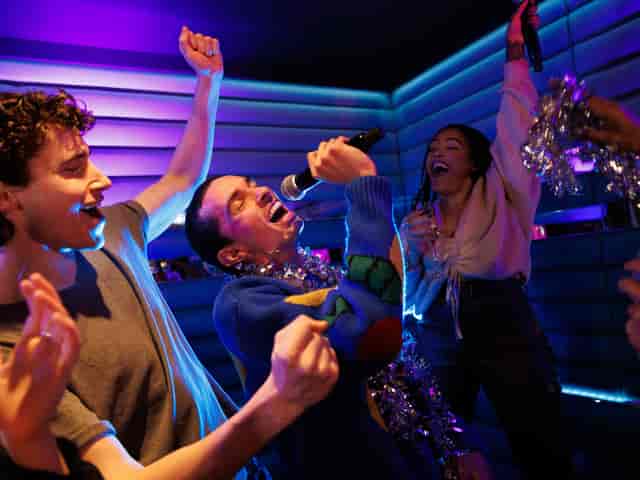 Christmas party at Lucky Voice Liverpool Street with karaoke and festive decorations.