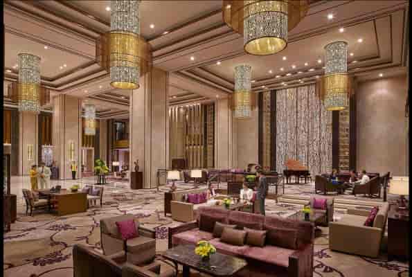 Krishna in luxurious Shangri-La Hotel lobby, ideal for networking events and meetings.