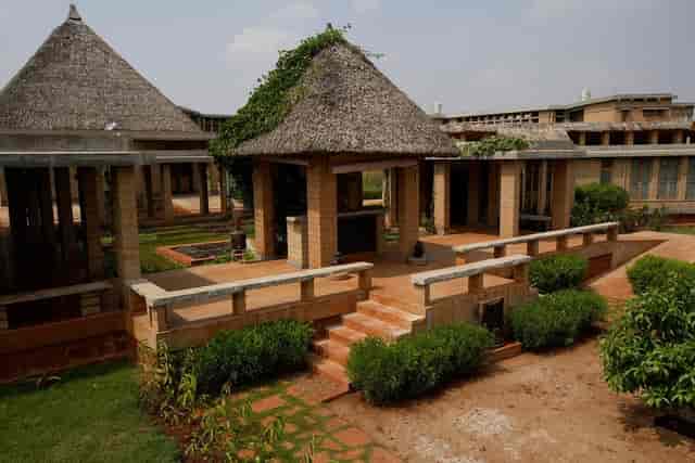 Catholic Club courtyard venue with thatched roofs for retreats and workshops.