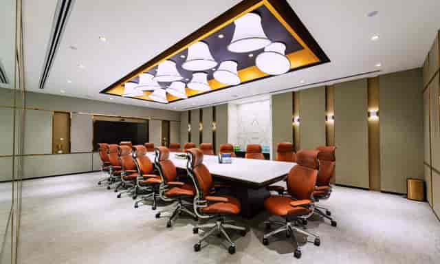 Modern conference room with spacious table, perfect for corporate meetings and presentations.