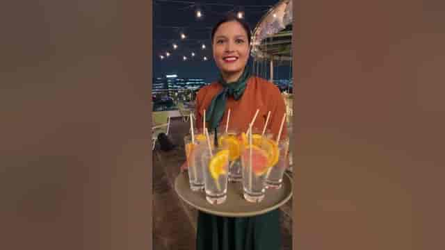 Professional server with cocktails at Echo Lounge Bar in Bengaluru for upscale events.