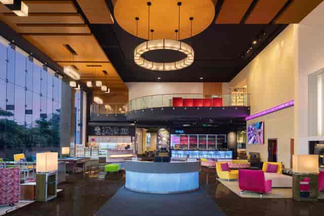 Modern lobby at Aloft Bengaluru, vibrant seating for corporate events and meetings.