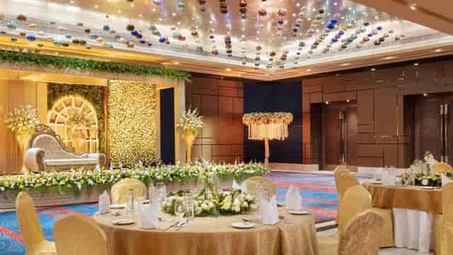 Elegant Sheraton Grand Bengaluru convention space with floral arrangements for weddings.