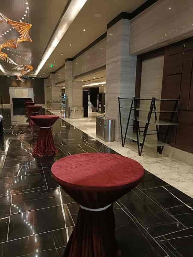 Heliconia event space at Sheraton Grand Bengaluru with red tables for receptions and networking.