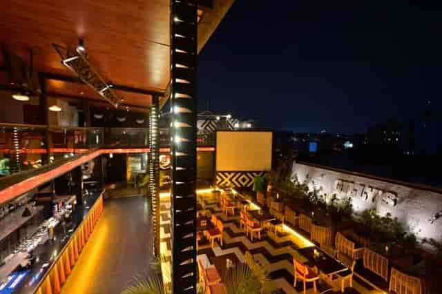 Vibrant rooftop dining area at Blue Waters for evening events and receptions.